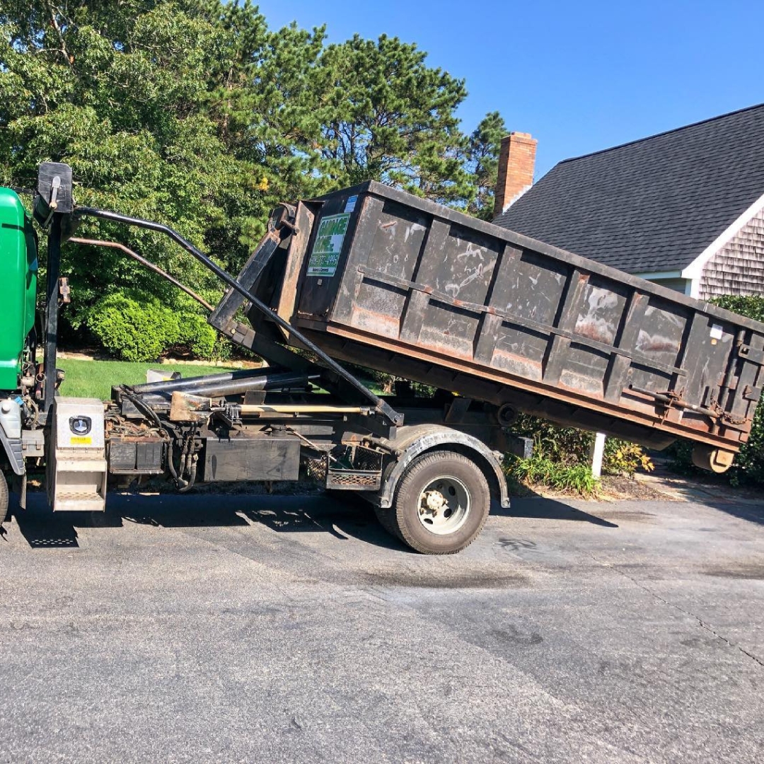 Truck with a roll-off dumpster